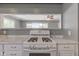An overview of a white gas stove and laminate countertops that open up to the living room space at 710 S Bancroft St, Indianapolis, IN 46203