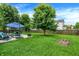 A well-manicured lawn leads to a patio area complete with dining furniture and grill at 7215 Braxton Dr, Noblesville, IN 46062
