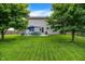 Backyard featuring a spacious patio with furniture, lush lawn, and a wooden fence at 7215 Braxton Dr, Noblesville, IN 46062