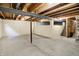 Unfinished basement with concrete floor, exposed beams and support columns at 7215 Braxton Dr, Noblesville, IN 46062