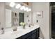 Bright bathroom featuring a double vanity, decorative mirror, and nautical themed decorations at 7215 Braxton Dr, Noblesville, IN 46062