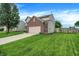 Beautifully maintained home with lush green lawn and mature landscaping at 7215 Braxton Dr, Noblesville, IN 46062