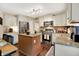 Well-lit kitchen with white cabinetry, stainless steel appliances, and a granite-topped island with seating at 7215 Braxton Dr, Noblesville, IN 46062