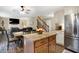 Open kitchen featuring granite counters, stainless steel appliances, island and an adjacent dining area with backyard access at 7215 Braxton Dr, Noblesville, IN 46062