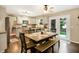 Bright kitchen and dining area with white cabinets, granite counters, stainless appliances and backyard access at 7215 Braxton Dr, Noblesville, IN 46062
