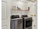 Convenient laundry area featuring modern front load washer and dryer and shelving at 7215 Braxton Dr, Noblesville, IN 46062