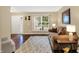 Bright living room with comfortable seating, decorative rug, and a large window for natural light at 7215 Braxton Dr, Noblesville, IN 46062
