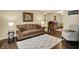Comfortable living room with a soft rug, a sofa and two armchairs at 7215 Braxton Dr, Noblesville, IN 46062