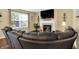 Comfortable living room featuring a fireplace, large TV, and oversized sectional sofa at 7215 Braxton Dr, Noblesville, IN 46062