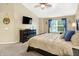 Bright main bedroom featuring a king-sized bed, large window, and dresser with TV at 7215 Braxton Dr, Noblesville, IN 46062