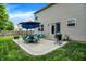 Backyard patio with dining set, blue umbrella, grill, and sliding door to the home at 7215 Braxton Dr, Noblesville, IN 46062