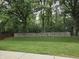 Spacious backyard featuring a mature tree line and wood fence, perfect for outdoor enjoyment at 7440 Oakview Dr, Avon, IN 46123