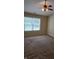 Bedroom featuring plush carpeting, ceiling fan, and ample natural light through a window at 7440 Oakview Dr, Avon, IN 46123