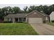 Charming brick ranch home with a two-car garage and well-maintained lawn at 7440 Oakview Dr, Avon, IN 46123
