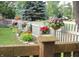 Charming white picket fence adorned with vibrant hanging baskets and colorful flowerpots at 7662 Micawber Ct, Indianapolis, IN 46256