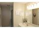 Neutral bathroom vanity features modern fixtures, a mirror, and three botanical artworks at 7662 Micawber Ct, Indianapolis, IN 46256