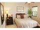 Relaxing bedroom featuring soft neutral colors, a ceiling fan, and bright natural light at 7662 Micawber Ct, Indianapolis, IN 46256