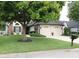Charming home featuring a large tree, brick accents, and a well-maintained front lawn and two-car attached garage at 7662 Micawber Ct, Indianapolis, IN 46256
