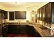 Stylish kitchen with dark cabinetry, granite countertops, and stainless steel appliances, perfect for cooking at 7662 Micawber Ct, Indianapolis, IN 46256