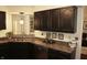 Charming kitchen featuring dark cabinets, granite countertops, and stainless steel appliances for a chef-inspired space at 7662 Micawber Ct, Indianapolis, IN 46256