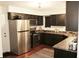 Stylish kitchen with stainless steel appliances, dark cabinetry, and a window providing plenty of natural light at 7662 Micawber Ct, Indianapolis, IN 46256