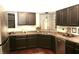 Well-appointed kitchen featuring dark cabinets, sleek countertops, and modern appliances for an efficient cooking space at 7662 Micawber Ct, Indianapolis, IN 46256