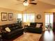 Comfortable living room featuring plush leather seating, a bright window, and a seamless connection to the outdoor area at 7662 Micawber Ct, Indianapolis, IN 46256