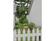 Beautifully landscaped side yard with a white picket fence, vibrant flowers, and lush plants at 7662 Micawber Ct, Indianapolis, IN 46256