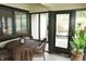 A peaceful enclosed sunroom with wicker furniture overlooking the backyard at 7662 Micawber Ct, Indianapolis, IN 46256