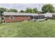 Aerial view of the backyard showcasing the lush green lawn and screen porch on this brick house at 784 S Restin Rd, Greenwood, IN 46142
