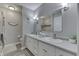 Well-lit bathroom with double sinks, white cabinets, a large mirror, and a decorative sign above the toilet at 784 S Restin Rd, Greenwood, IN 46142