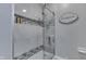 Well-maintained bathroom shower with tiled walls, glass door, and convenient built-in shelving at 784 S Restin Rd, Greenwood, IN 46142
