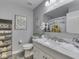 Bathroom features a white marble vanity with chrome faucet, toilet, decorative mirror, and wooden shelving at 784 S Restin Rd, Greenwood, IN 46142