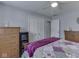 Bedroom features neutral paint, modern carpet, bed, dresser, and a closet at 784 S Restin Rd, Greenwood, IN 46142