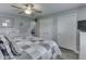 A spacious bedroom with two closets and neutral decor featuring gray walls and wood-look flooring, and a patchwork quilt on the bed at 784 S Restin Rd, Greenwood, IN 46142