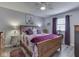Bedroom features neutral paint, modern carpet, ceiling fan, bed, and matching end tables at 784 S Restin Rd, Greenwood, IN 46142