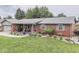 Inviting brick home with lush landscaping, a cozy porch, and an attached garage at 784 S Restin Rd, Greenwood, IN 46142