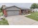 Quaint home with a brick facade, attached garage, and a welcoming walkway through landscaped gardens at 784 S Restin Rd, Greenwood, IN 46142