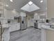 Bright kitchen featuring white cabinets, stainless steel appliances, and a skylight providing natural light at 784 S Restin Rd, Greenwood, IN 46142
