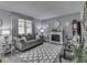Cozy living room featuring a fireplace, gray sofa, and plush rug, creating an inviting atmosphere at 784 S Restin Rd, Greenwood, IN 46142