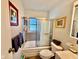 Bright bathroom with a tub, shower, and a decorative shower door at 7918 Bonita Ct, Indianapolis, IN 46219
