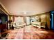 Inviting living room featuring cozy seating, wood paneling, and a decorative piano at 7918 Bonita Ct, Indianapolis, IN 46219