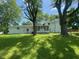 Expansive backyard with lush greenery, mature trees, and a bright, sunlit atmosphere at 8008 Cherington Dr, Indianapolis, IN 46227