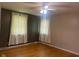 Bedroom featuring natural light and two windows, complemented by a ceiling fan and hardwood floors at 8008 Cherington Dr, Indianapolis, IN 46227