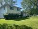 Charming exterior featuring a partial white brick facade, and well-maintained front lawn with green space at 8008 Cherington Dr, Indianapolis, IN 46227