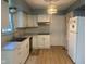 Updated kitchen featuring white cabinets, modern appliances, and wood-look flooring at 8008 Cherington Dr, Indianapolis, IN 46227
