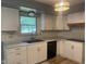 Updated kitchen with white cabinets, modern appliances and backsplash at 8008 Cherington Dr, Indianapolis, IN 46227