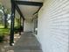 White brick house with a black beam porch, black columns, a bay window, and concrete steps at 8008 Cherington Dr, Indianapolis, IN 46227