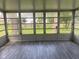Enclosed sunroom features walls of windows, and wood-look flooring at 8008 Cherington Dr, Indianapolis, IN 46227