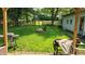 Grassy backyard featuring a wooden fence and a grill at 8201 S Burlington Dr, Muncie, IN 47302